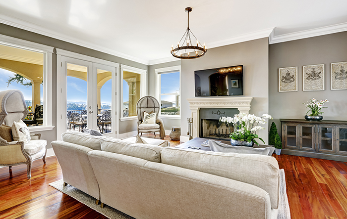 Bright luxury living room with fireplace and tv. Corner decorated with antique hood chairs